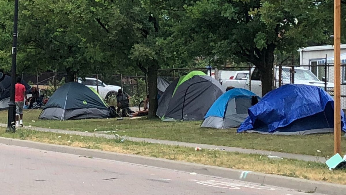 A photo of tents set up along a sidewalk in Hamilton, Ont.