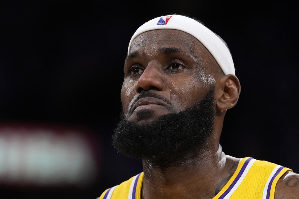 LeBron James with tears in his eyes. He is in his Lakers uniform.