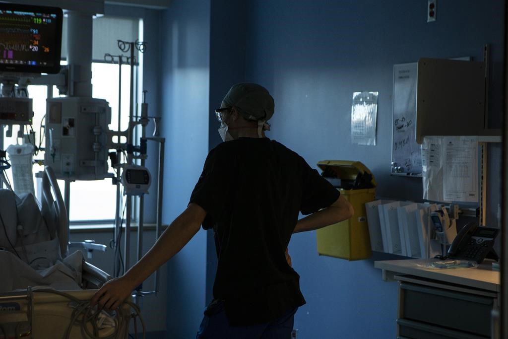 FILE - A nurse tends to a patient at the Bluewater Health Hospital in Sarnia, Ont., on Wednesday, Jan, 26, 2022. 