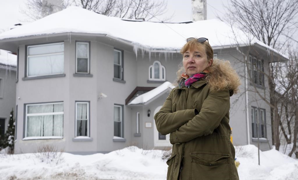 Elena Pushkareva poses for a photo in front of the Russian consular affairs building, Thursday, Feb. 2, 2023 in Ottawa. THE CANADIAN PRESS/Adrian Wyld