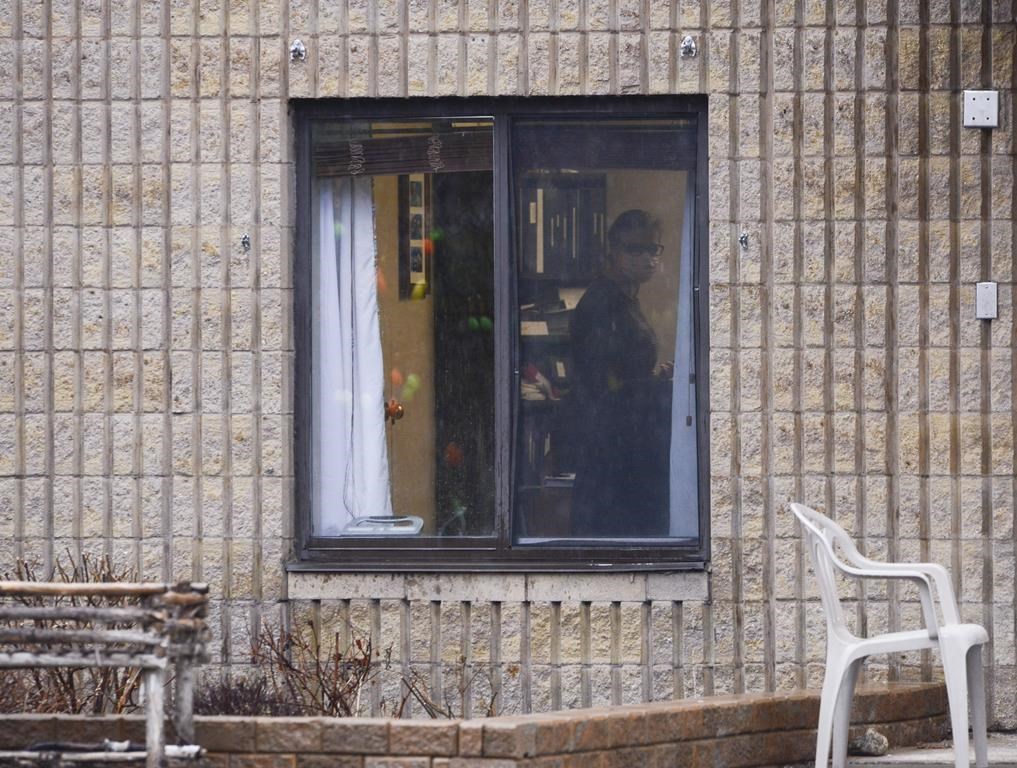 Ontario is proposing to increase fines to long-term care homes that do not have air conditioning in every room. A worker is shown through a window at a long-term care home in Almonte, Ont. on Thursday, April 9, 2020. 