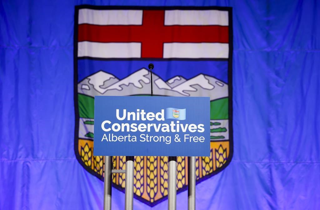 A United Conservative Party of Alberta sign is shown in front of the Alberta flag prior to the party's leadership announcement in Calgary on Thursday, Oct. 6, 2022. Alberta's rivals United Conservative Party and NDP remain deadlocked in the polls 68 days before the provincial election, a ThinkHQ survey suggests. THE CANADIAN PRESS/Jeff McIntosh.