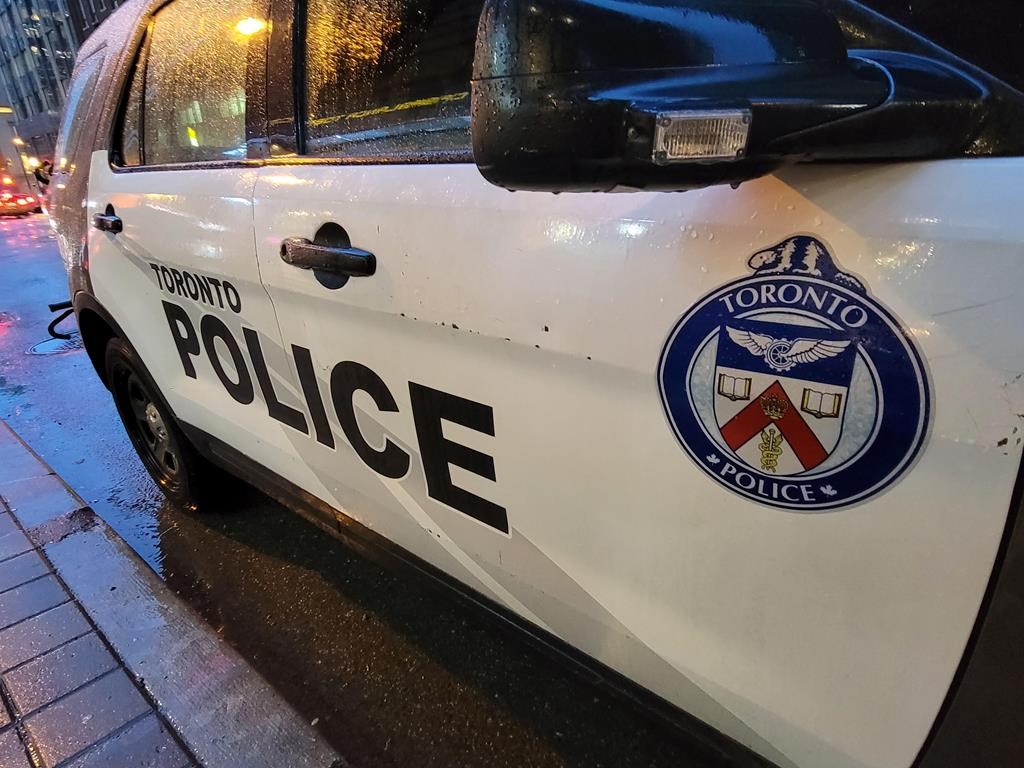 A Toronto police vehicle is shown parked on Yonge Street as rain falls in downtown Toronto on Tuesday Jan. 3, 2023.
