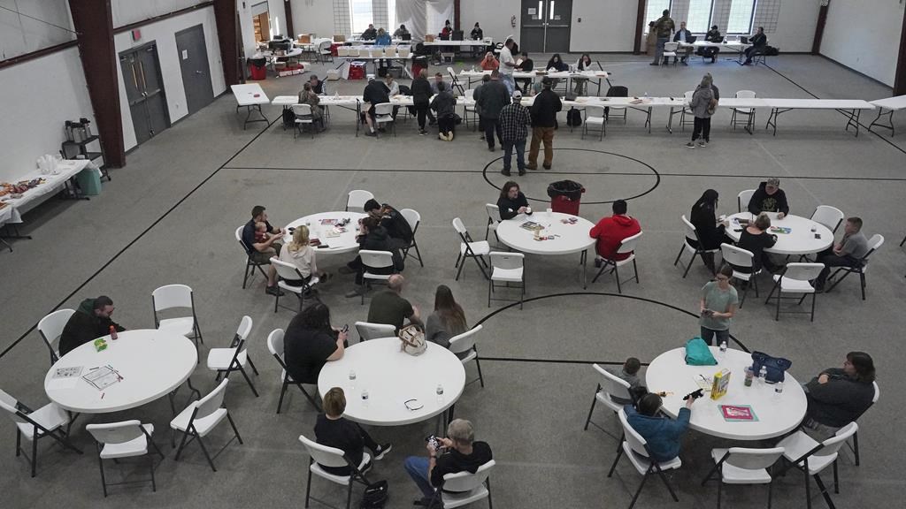 People gather at the Norfolk Southern Railways Assistance Center Thursday, Feb. 9, 2013, at the Abundant Life Fellowship in East Palestine, Ohio.
