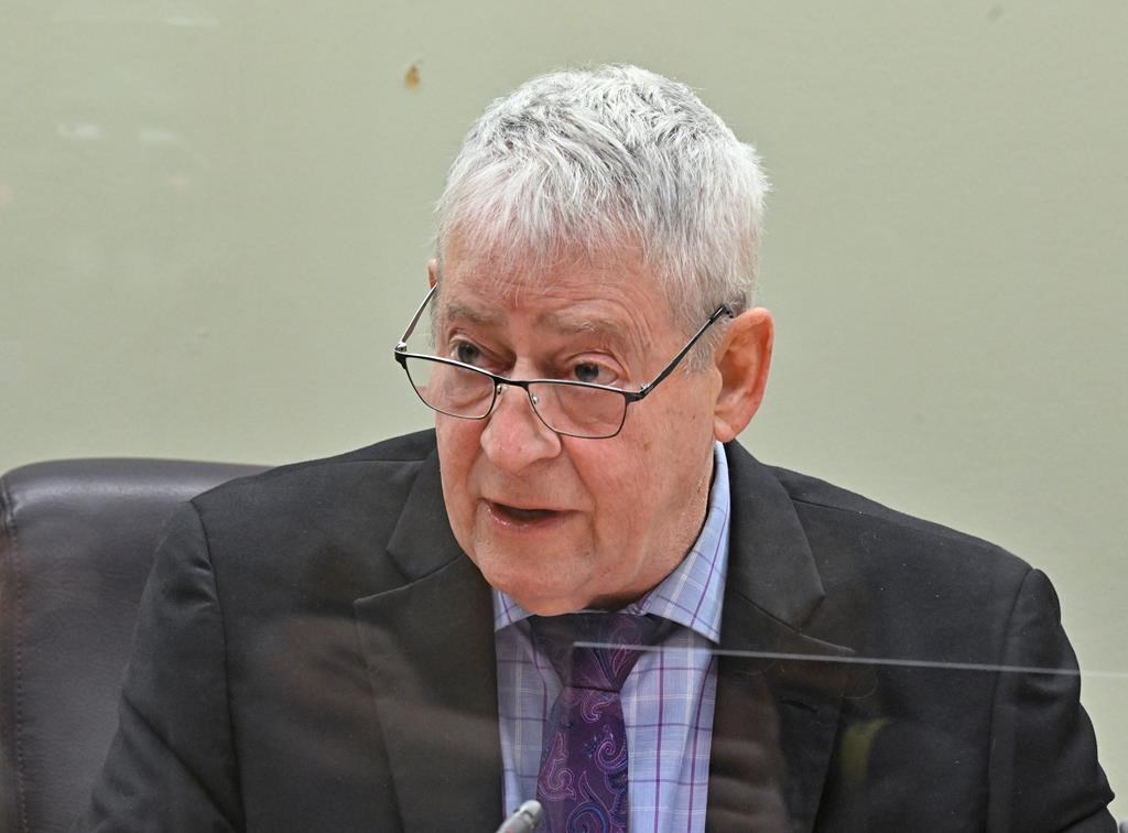 Quebec coroner Luc Malouin speaks at the beginning of a Coroner’s inquest into the deaths of Romy, Norah and Martin Carpentier, Monday, February 13, 2023 in Quebec City. A provincial police dog handler who arrived at the scene of a crash involving the girls and their father says he had difficulty doing his job because the scene had been contaminated by first responders who had been searching. 
