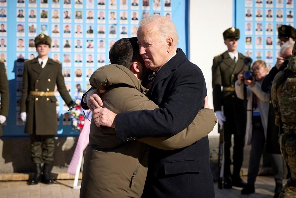 President Joe Biden, right, and Ukrainian President Volodymyr Zelenskyy hug as they say goodbye at the Memorial Wall of Fallen Defenders of Ukraine in Russian-Ukrainian War, in Kyiv, Ukraine, Monday, Feb. 20, 2023. (Ukrainian Presidential Press Office via AP)
