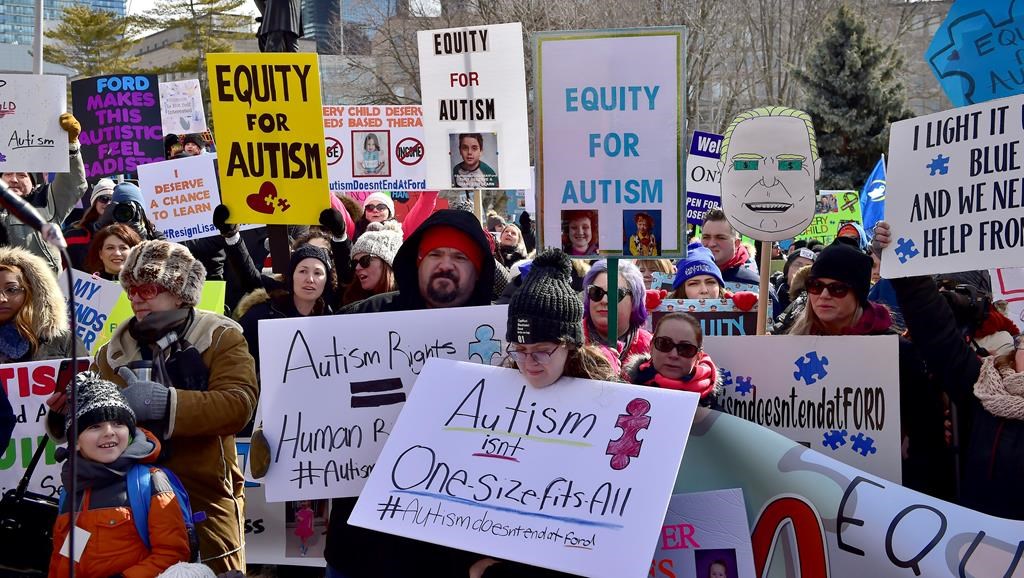 Hundreds of parents, therapists and union members gather outside Queen's Park, in Toronto on Thursday, March 7, 2019, to protest the provincial government's changes to Ontario's autism program. THE CANADIAN PRESS/Frank Gunn.