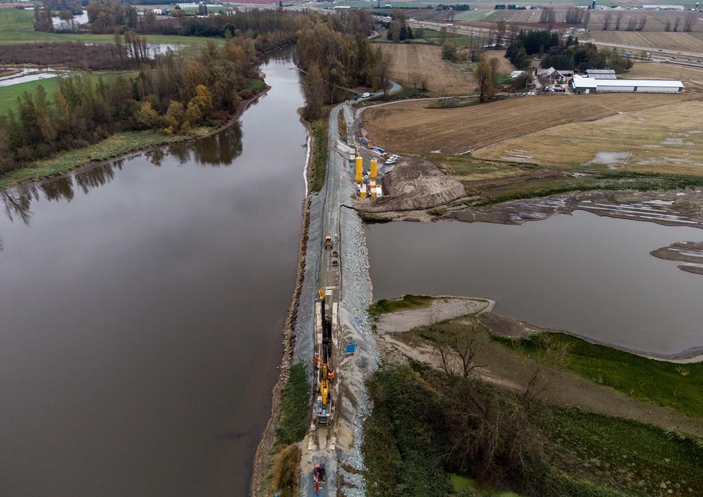 Heavy equipment is used as permanent repairs to the Sumas River dike are seen underway in Abbotsford, B.C., on Thursday, Nov. 10, 2022. Local governments and First Nations in British Columbia are getting more support to prepare for the risk of natural disasters related to climate change. THE CANADIAN PRESS/Darryl Dyck.