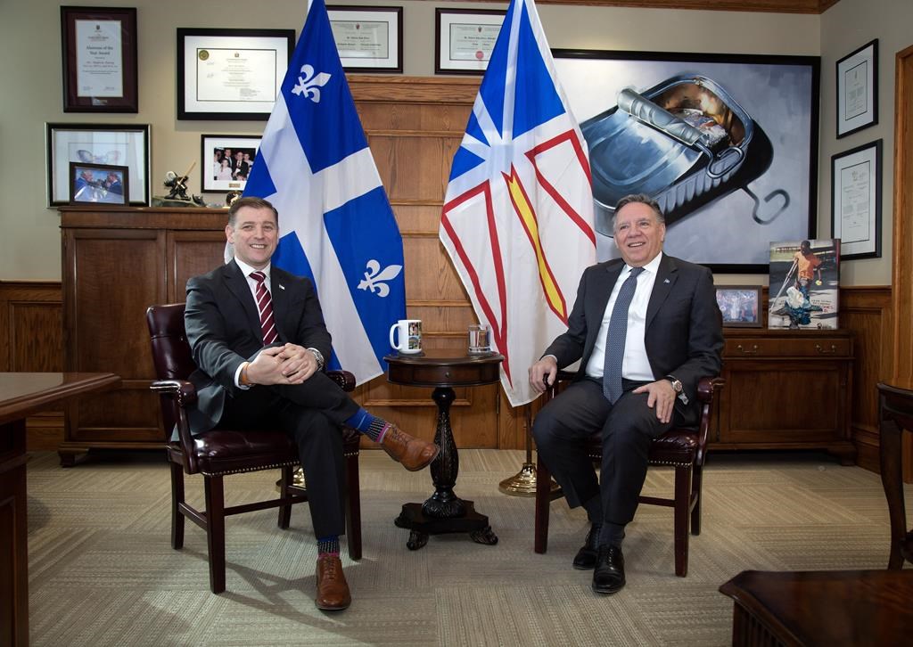 Newfoundland and Labrador Premier Andrew Furey and Quebec Premier François Legault pose in the office of the premier at the Confederation Building, in St. John's, on Friday, Feb. 24, 2023. 