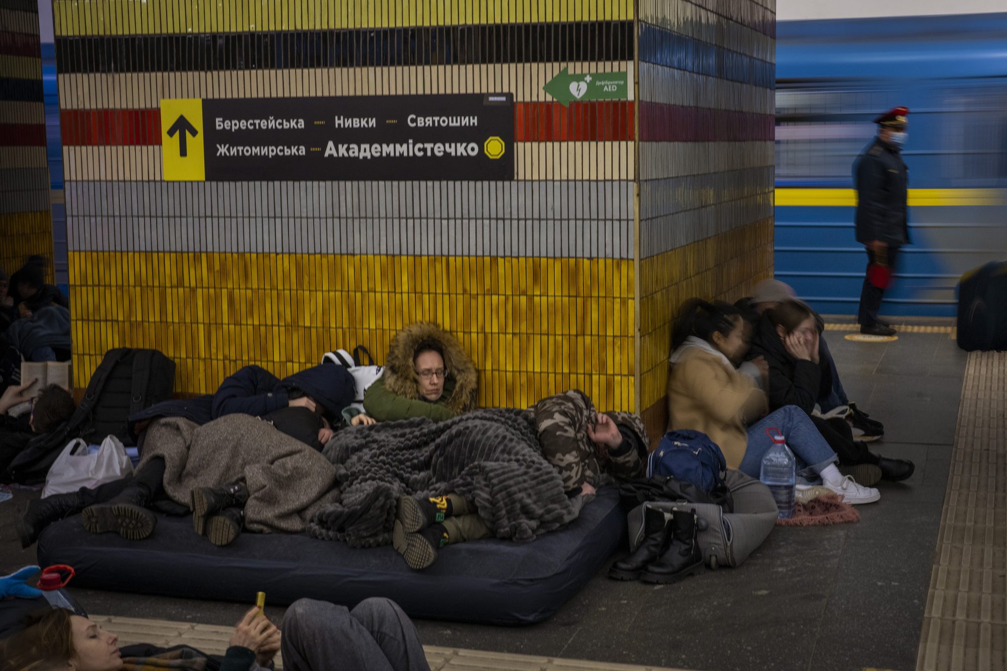 People sleep in the Kyiv subway, using it as a bomb shelter in Kyiv, Ukraine, Friday, Feb. 25, 2022. In Ukraine’s capital, many residents hurried underground for safety overnight Thursday and Friday as Russian forces fired on the city and moved closer. (AP Photo/Emilio Morenatti)