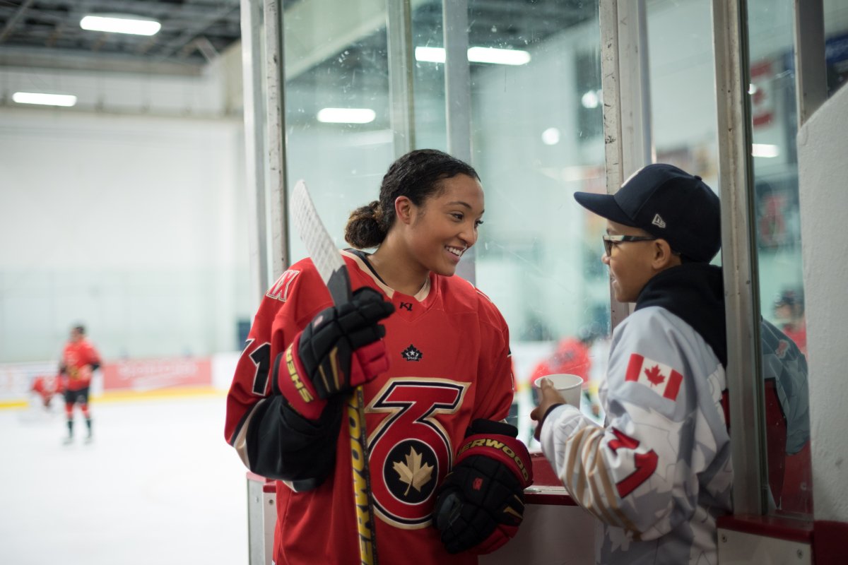 Saroya Tinker of the Toronto Six of the Premier Hockey Federation is greeted by her brother Malachi, 12, after an on-ice warm-up before a home game against the Connecticut Whale, at  Canlan Sports at York University in Toronto, on Saturday, January 21, 2023.  THE CANADIAN PRESS/ Tijana Martin.