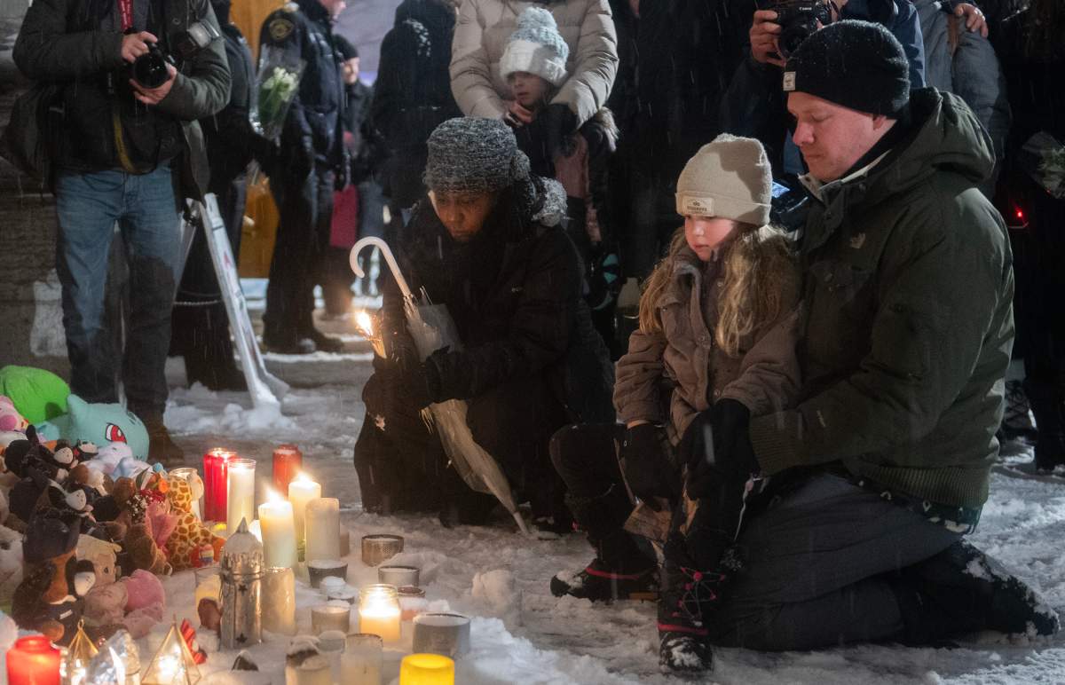 People attend a vigil at a church near the site of a daycare centre where two children lost their lives after a city bus crashed into the building in Laval, Que, Thursday, February 9, 2023. THE CANADIAN PRESS/Graham Hughes