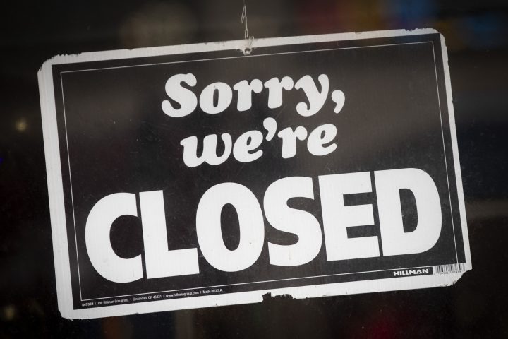 A close up of a sign saying "Sorry, we're CLOSED"