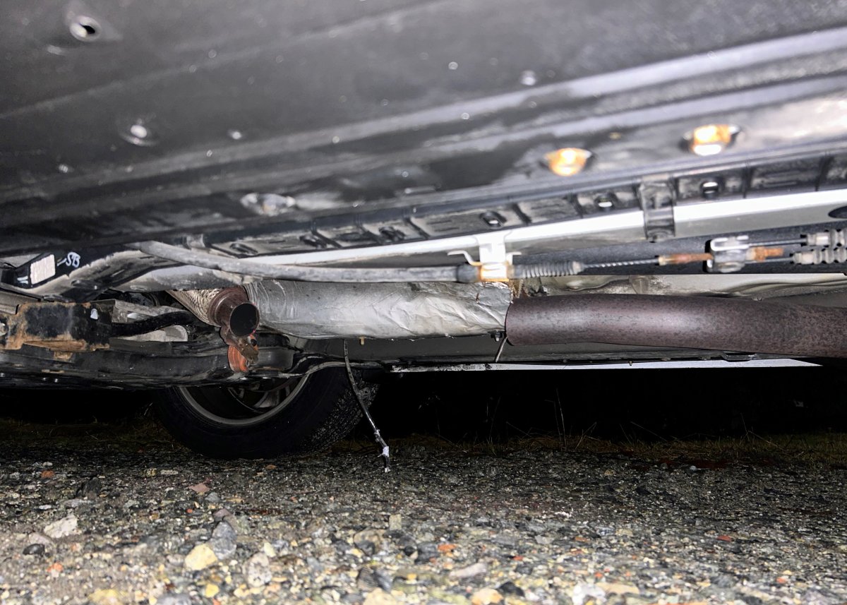 The undercarriage of a vehicle that has had its catalytic converter stolen.