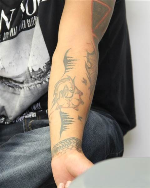 Tattoos on the left arm of Edmonton homicide suspect Donn Austin Gauthier.