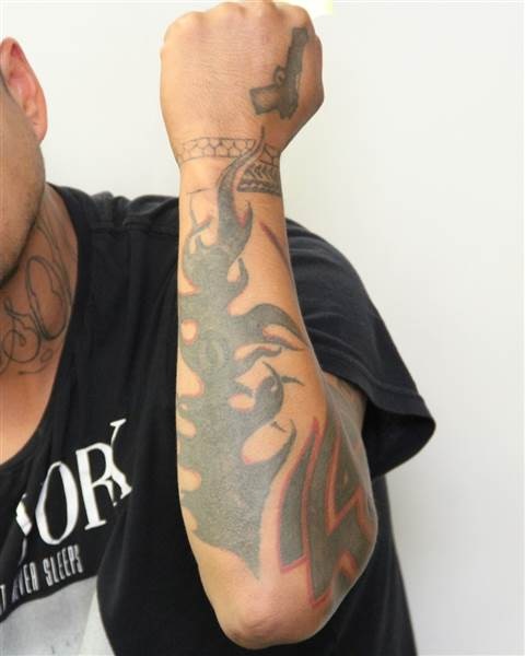 Tattoos on the left arm of Edmonton homicide suspect Donn Austin Gauthier.