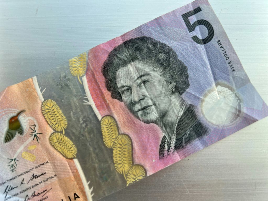 This file photo shows the Australian $5 banknote. - Australia's central bank announced on February 2, 2023 it will erase the British monarch from its banknotes, replacing the late Queen Elizabeth II's image on its $5 note with a design honouring Indigenous culture.