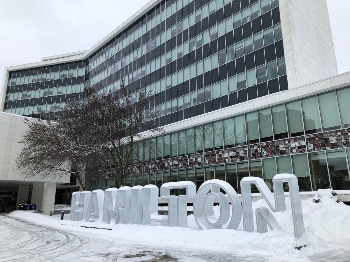 The Hamilton sign in front of city hall covered in snow after heavy snowfall.