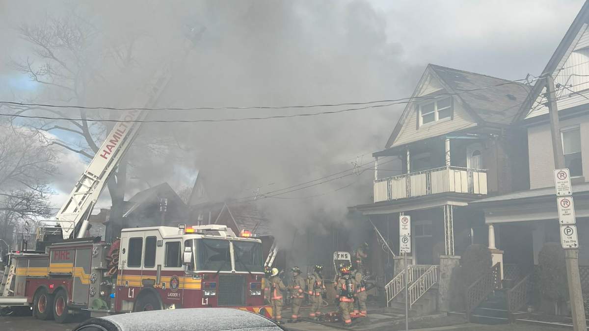 Firefighters battle a blaze at a residential home on Century Street in Hamilton Feb. 17, 2023.