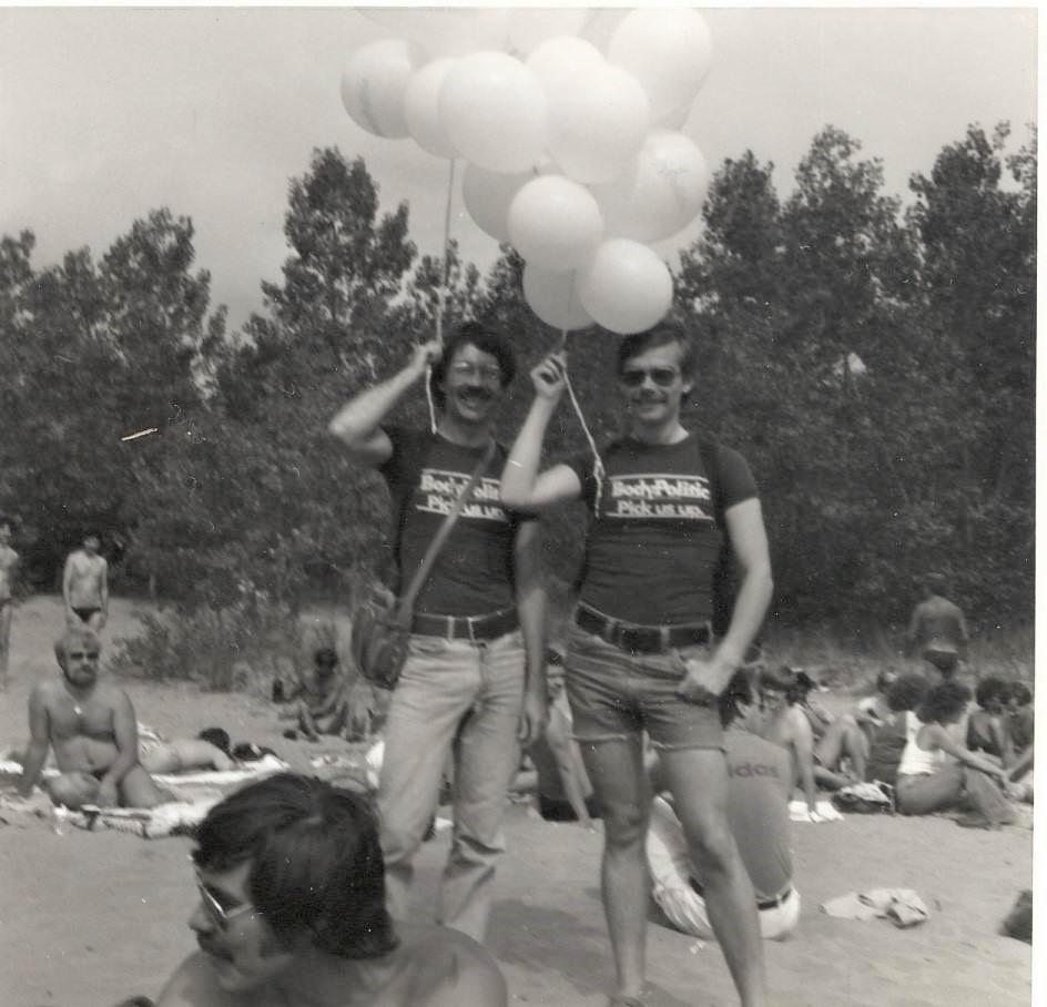 Two men pose with balloons on Hanlan's Point Beach in 1978