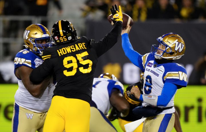 Winnipeg Blue Bombers quarterback Zach Collaros (8) throws the ball under pressure from Hamilton Tiger-Cats defensive end Julian Howsare (95) during second half football action in the 108th CFL Grey Cup in Hamilton, Ont., on Sunday, December 12, 2021. 