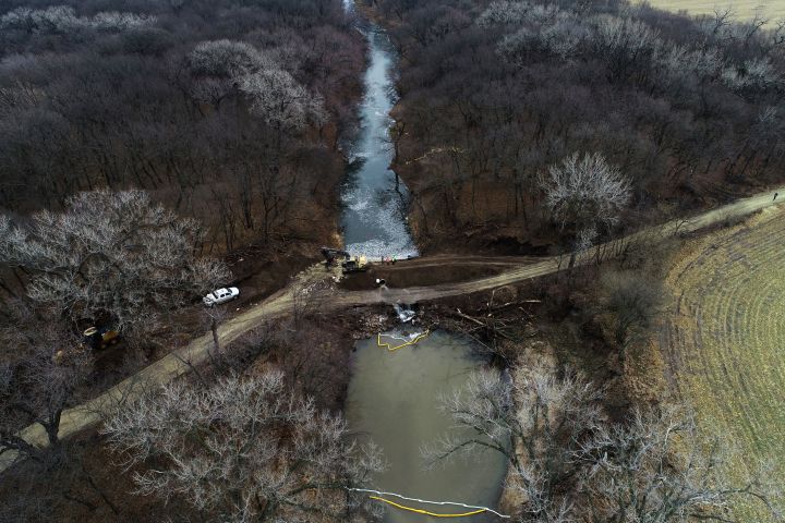 FILE - In this photo taken by a drone, cleanup continues in the area where the ruptured Keystone pipeline dumped oil into a creek in Washington County, Kan., Dec. 9, 2022. The Environmental Protection Agency announced Monday, Jan., 9, 2023, that it has reached an agreement with a pipeline operator to clean up a spill that dumped 14,000 bathtubs’ worth of crude oil into a rural Kansas creek. 