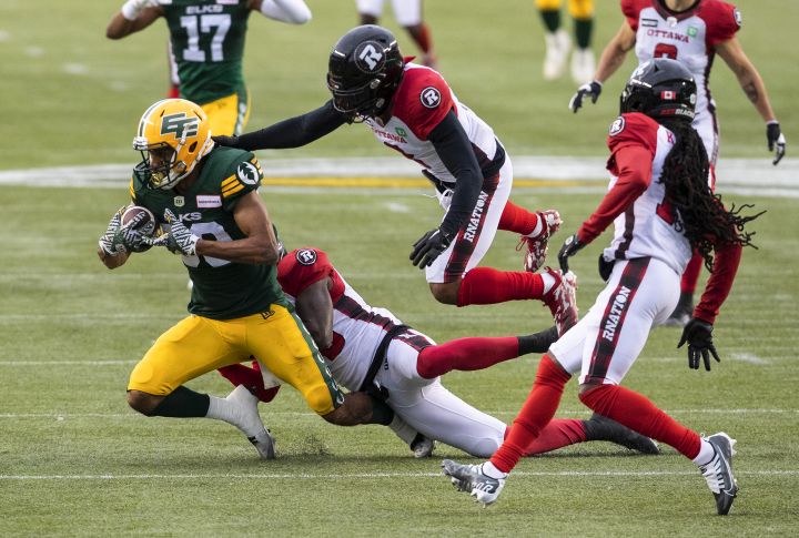 Ottawa Redblacks Patrick Levels (3) tackles Edmonton Elks Kenny Lawler (89) during first half CFL action in Edmonton, Alta., on Saturday August 27, 2022.