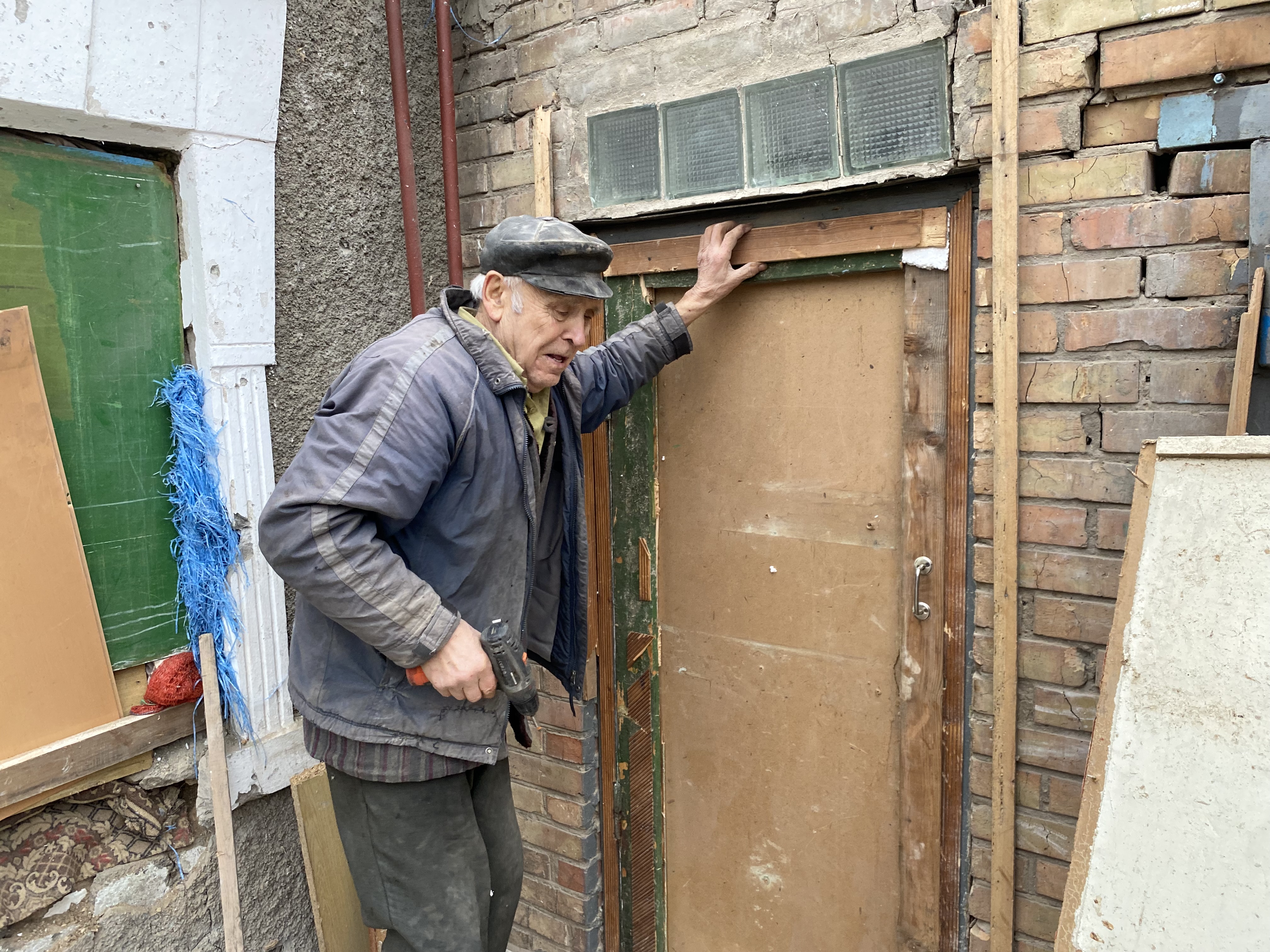 Man repairs damage to home in Marhanets, Ukraine, caused by Russian shelling from around Zaporizhzhya power plant, Jan. 23, 2023.