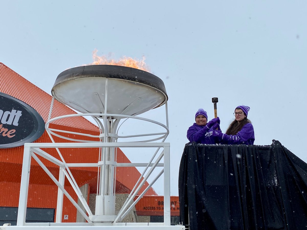 Athletes Peyton Daniels and Kya Ladouceur lit the torch at the Saskatchewan Winter Games torch relay on Sunday. 