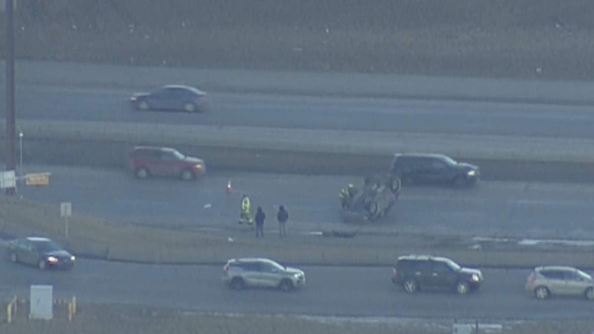 A red SUV at rest on its roof on Deerfoot Trail is pictured in Calgary on Feb. 10, 2023.