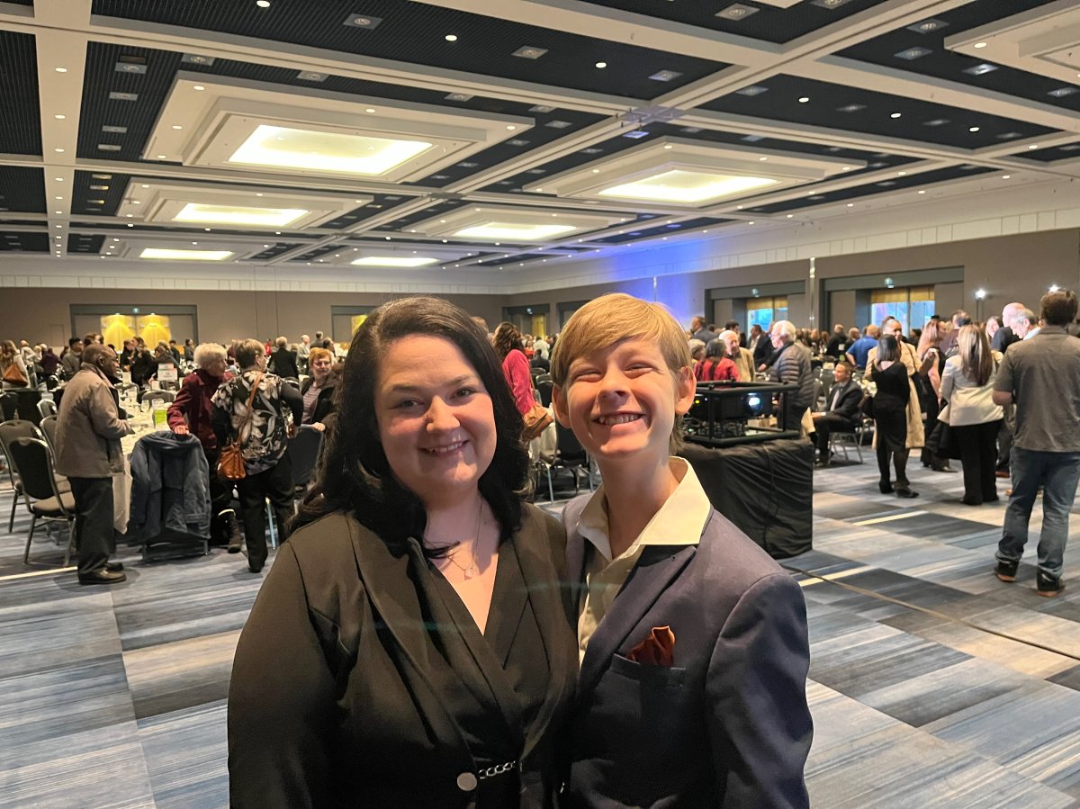 Cheyenne Vanderwoude is joined by her son during the 17th annual Breakfast for YOU, where she provided remarks as the event's featured speaker.