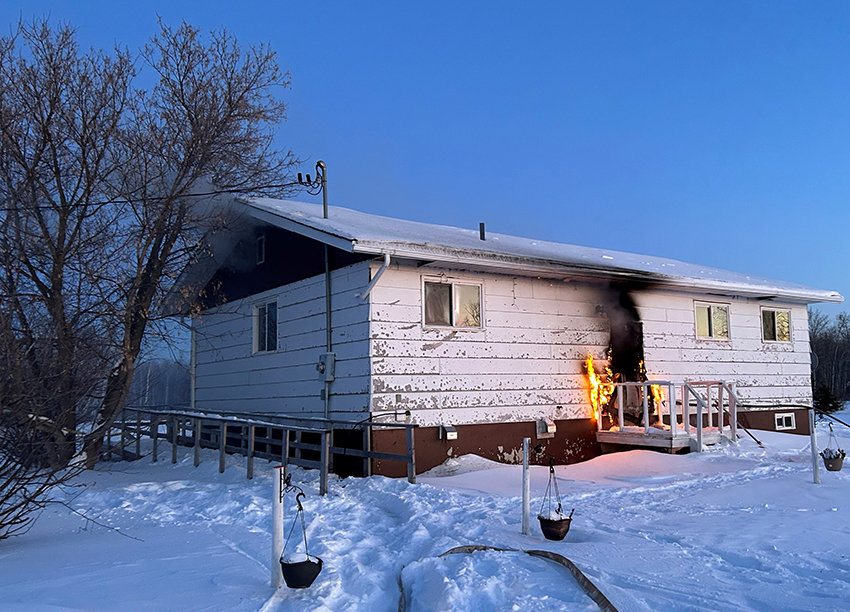 Police say fire broke out at a home on Peguis First Nation after a suspect wanted in connection with a stabbing allegedly barricaded himself in the home Monday.