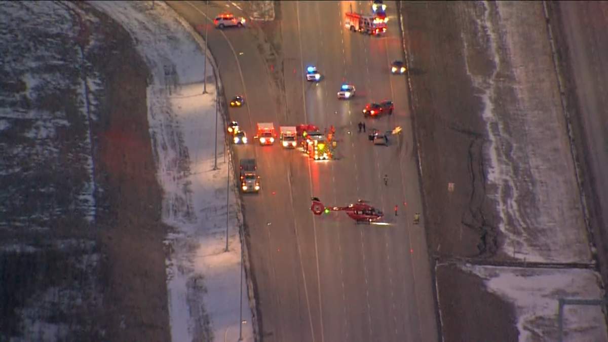 A STARS air ambulance helicopter is pictured landing on Highway 2 near Okotoks, Alta., on Feb. 14, 2023.