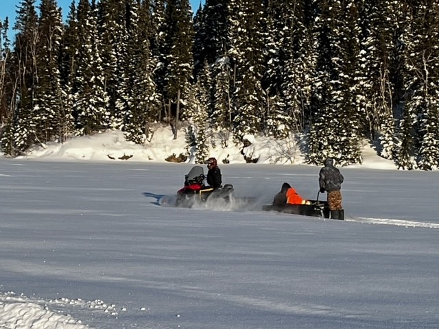 Manitoba RCMP officers head out on snowmobiles to rescue three trapped men.