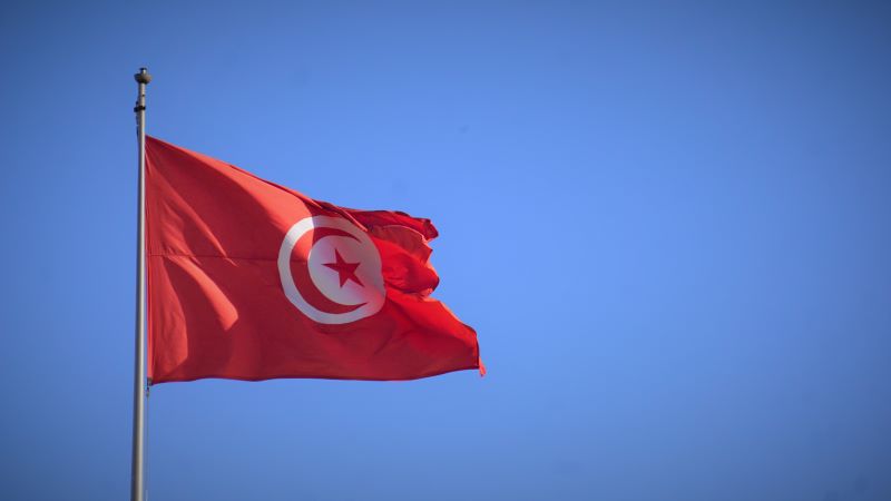 A Tunisia flag waves from a national government building in central Tunis on Sun. Feb. 5, 2023.