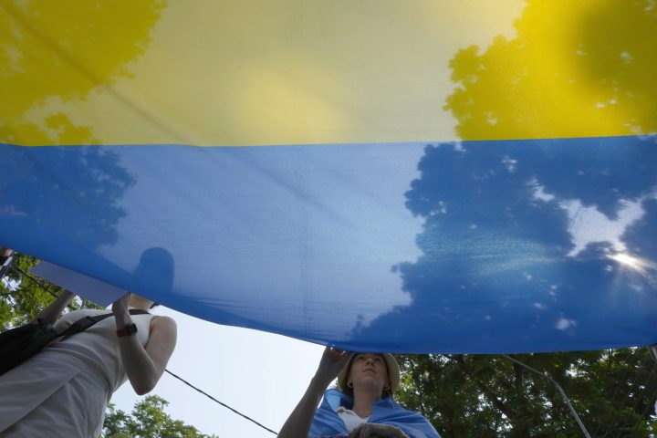 Ukrainian people living in Thailand hold Ukraine’s national flag during a rally to mark the one-year anniversary of Russia’s invasion of Ukraine, in Bangkok, Thailand, Friday, Feb. 24, 2023.