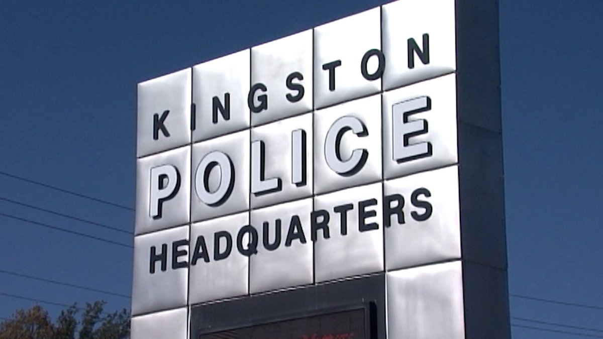 Kingston Police headquarters sign posted at the entrance to the building.