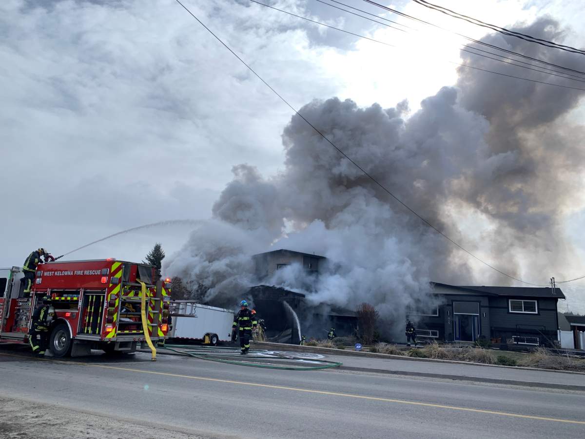 Smoke rises from a house fire in West Kelowna on Thursday at noon.