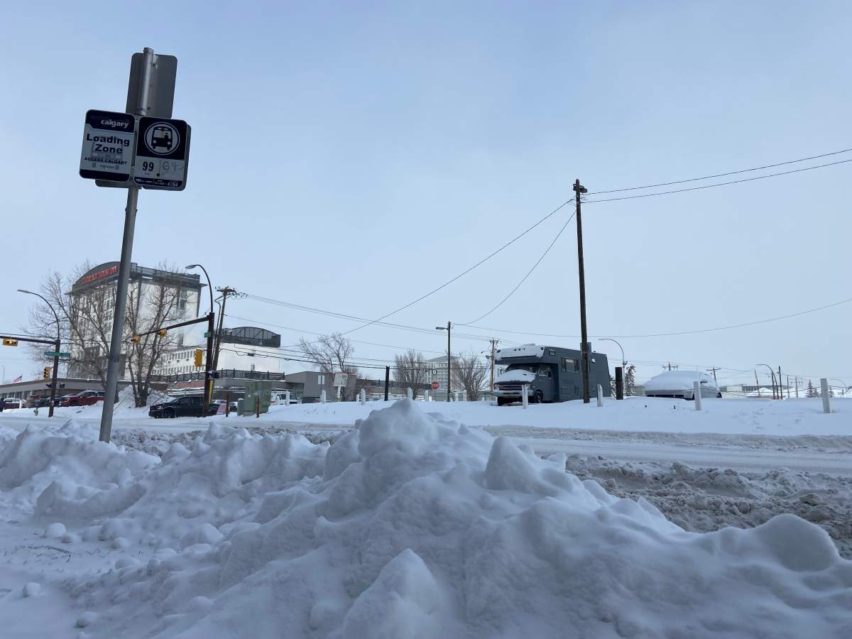 Snow piled around Access bus stop.