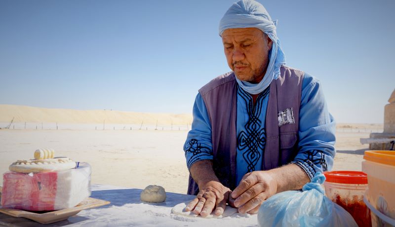 An Amazigh man makes bread at Ong Jemel in Chott el-Gharsa, Tunisia, on Wed. Feb. 1, 2023.