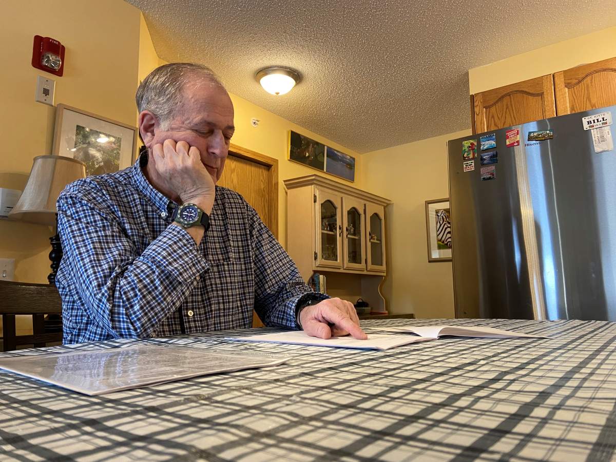 Bill Levy looking over his condo documents.