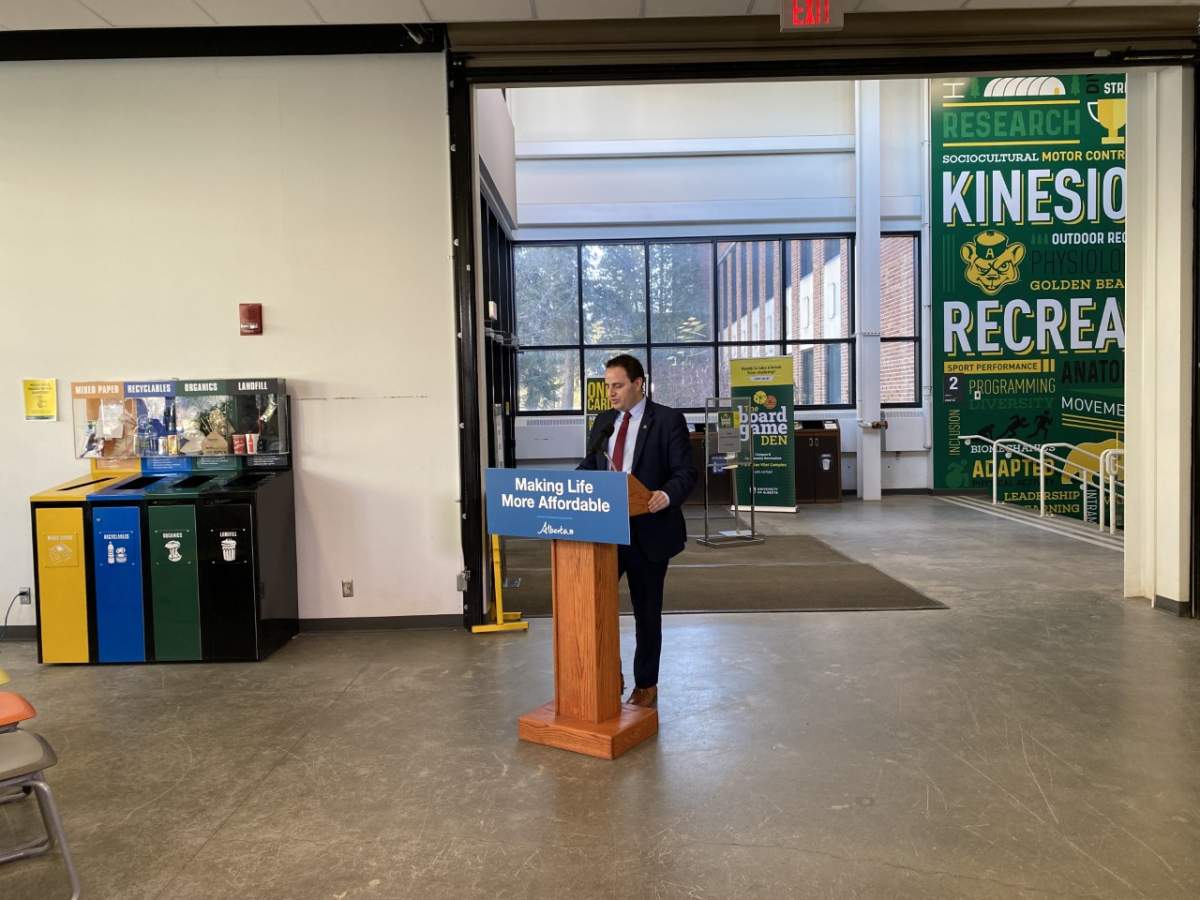 Alberta’s Advanced Education Minister Demetrios Nicolaides standing at a podium in a University of Alberta building on Feb. 16, 2023.