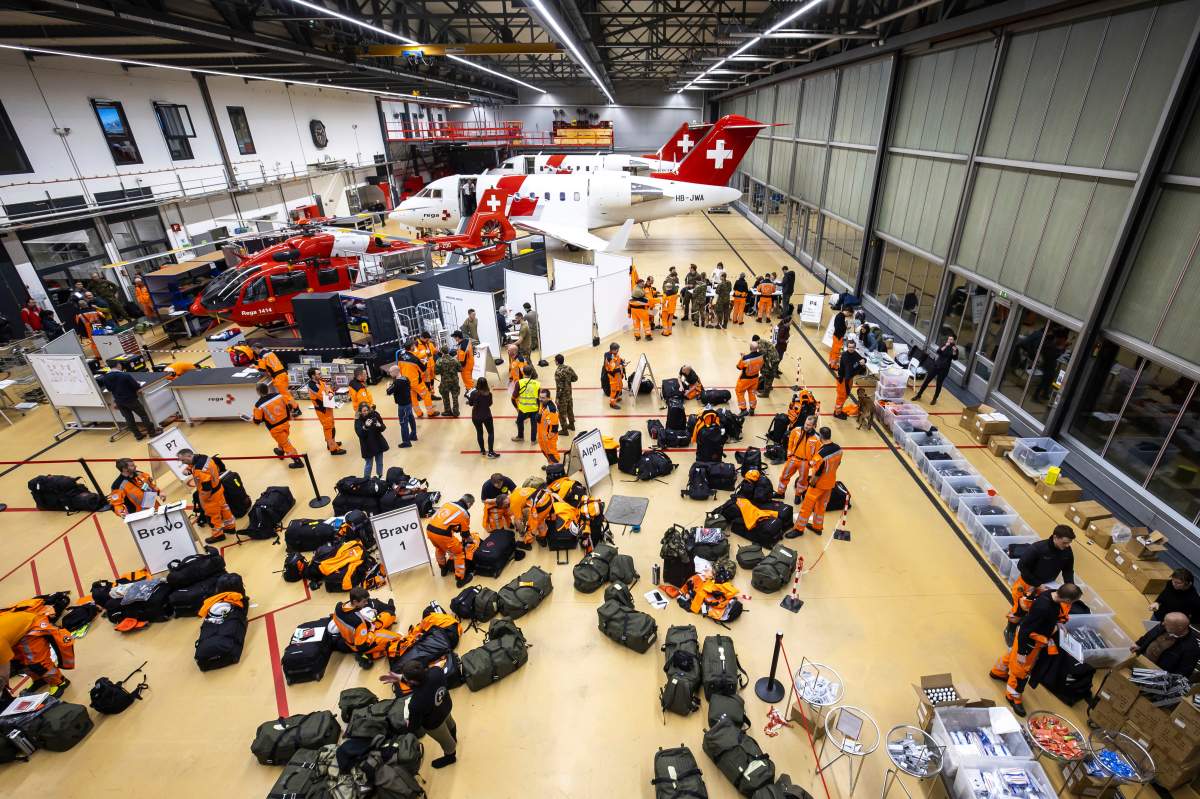 Swiss experts and rescuers with service dogs prepare to fly to the earthquake-hit Turkey.