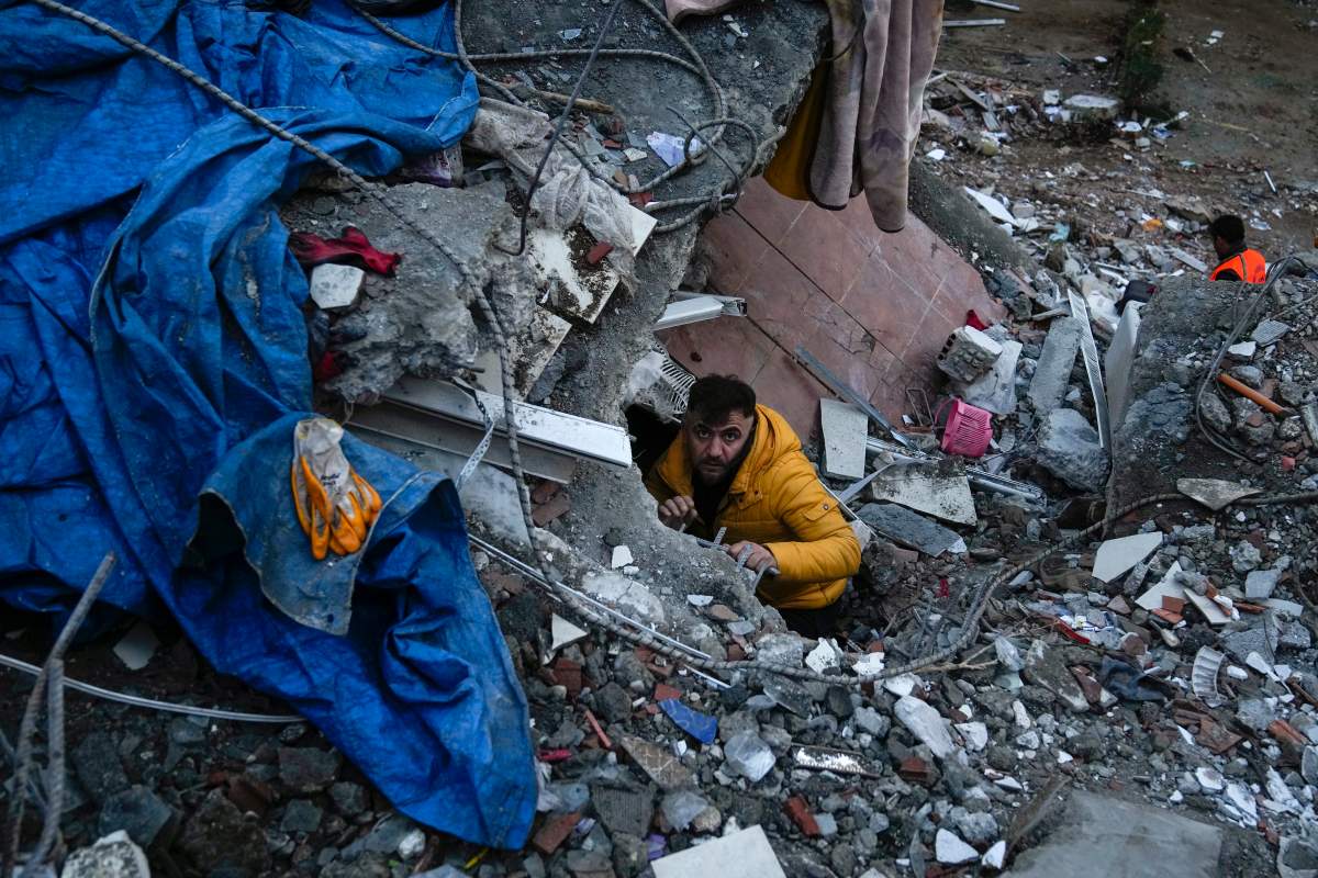 A man searches for people in the rubble of the Turkish earthquake.