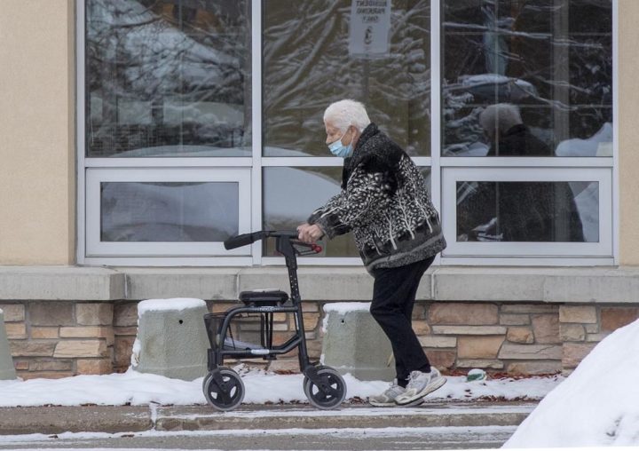 A woman walks outside a long-term care home in Barrie, Ont. on Monday, January 18, 2021. Ontario's long-term care minister says the province is reviewing pricing practices of nursing agencies. 