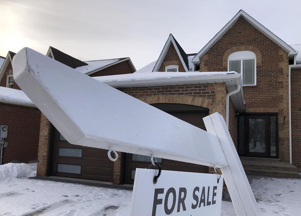A house for sale sign is shown in front of a house in Oakville, Ont., west of Toronto, Sunday, Feb.5, 2023. The Toronto Regional Real Estate Board says last month's home prices fell almost 18 per cent from last February as the number of properties sold was halved. THE CANADIAN PRESS/Richard Buchan.