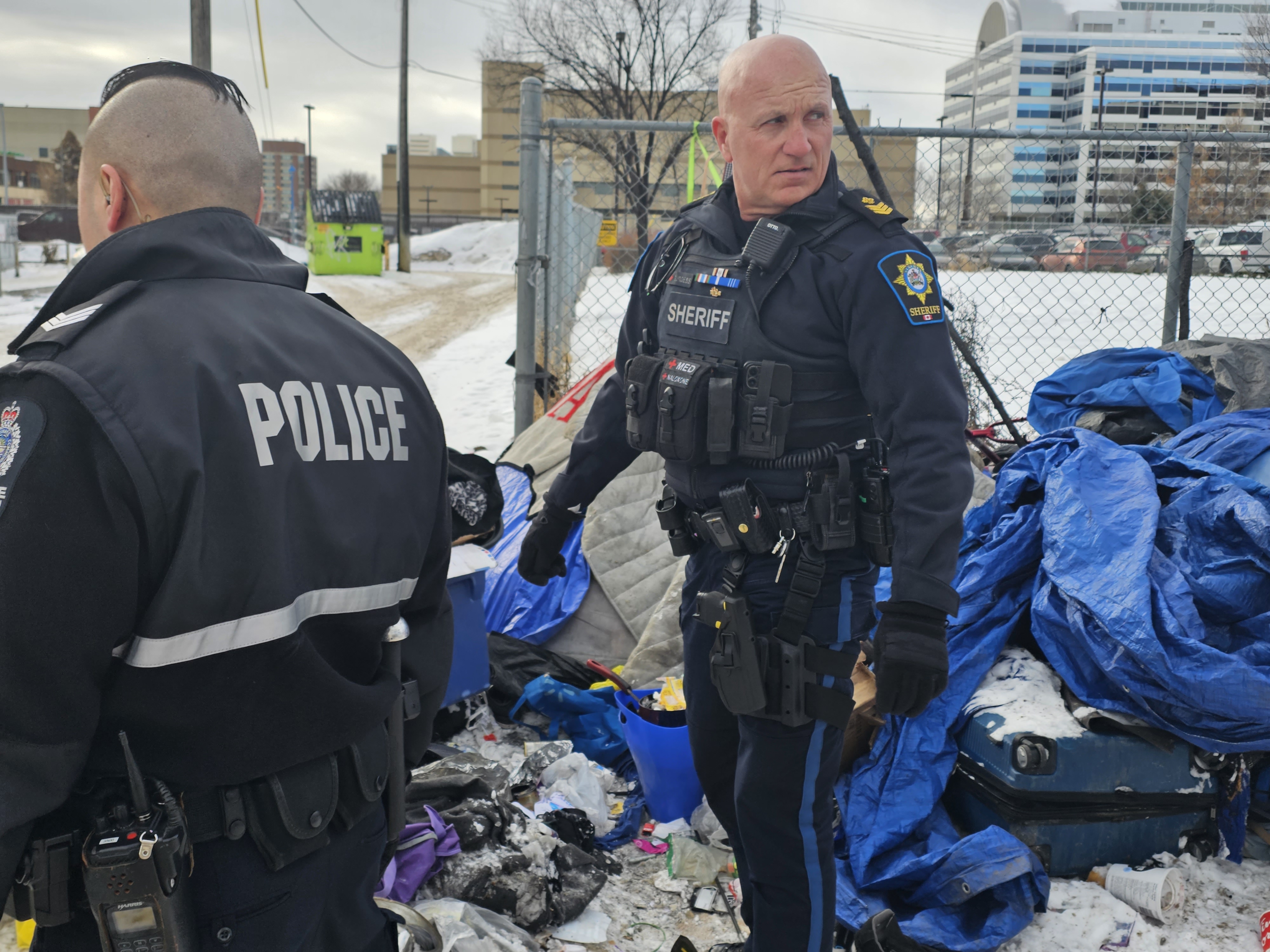 An Alberta Sheriff and Edmonton Police Service officer near a homeless encampment north of downtown Edmonton, Alta. on Thursday, March 2, 2023.