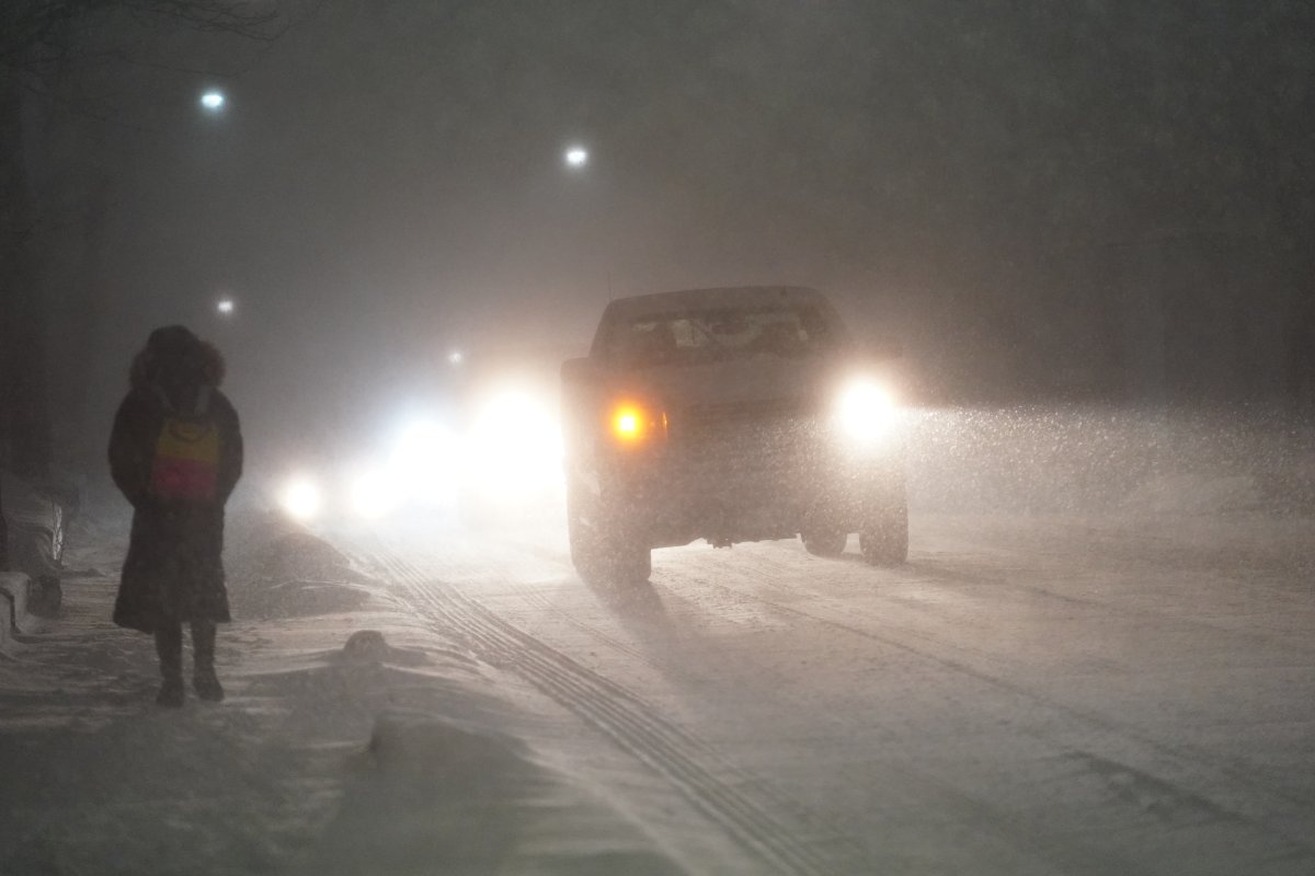 FILE - Cars drive during a snow storm in Toronto, Friday, March 3, 2023. 