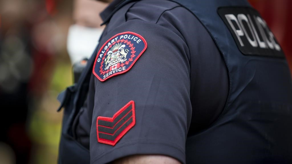 A Calgary Police Service badge is seen on a police officer in Calgary, Alta., Tuesday, April 14, 2020. The Calgary Police Service is seeking two suspects believed to be responsible for a random attack at a CTrain station that left a victim seriously injured. THE CANADIAN PRESS/Jeff McIntosh.