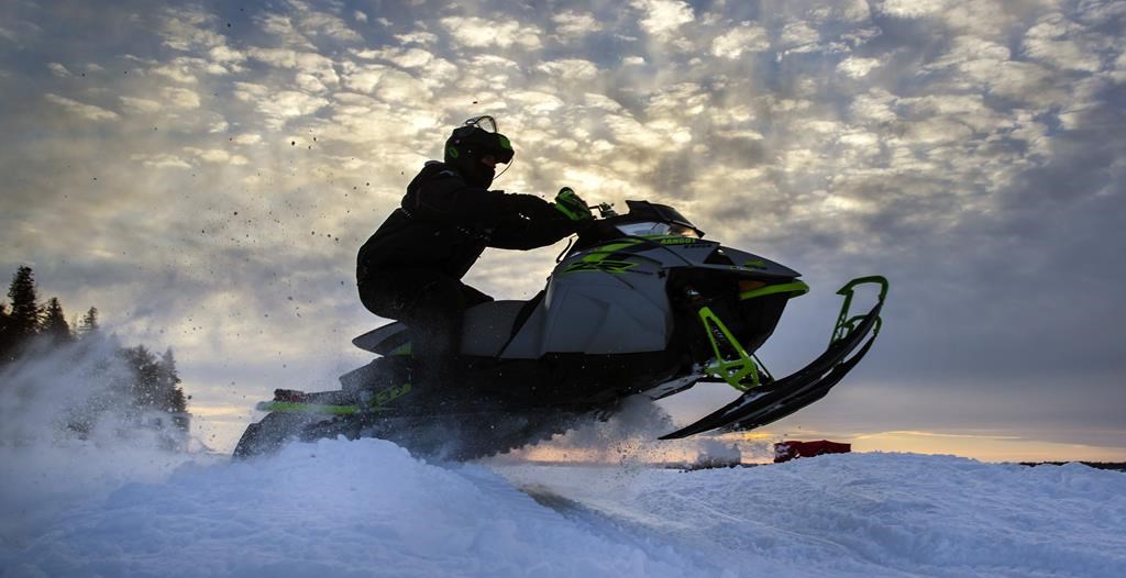 A snowmobiler warms up at an event on Sturgeon Lake in the city of Kawartha Lakes, Ont., Sunday, February 20, 2022.